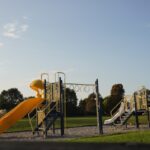 a playground with a yellow slide and a yellow slide
